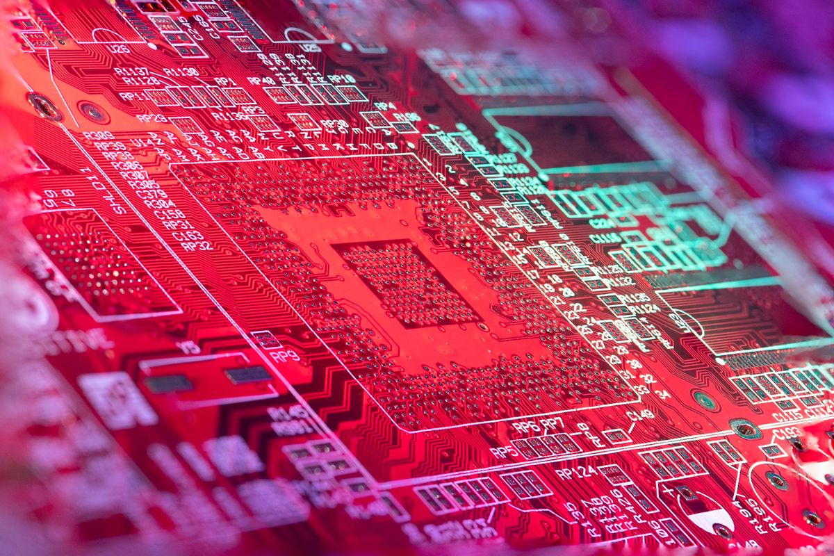 Red illuminated circuit board representing continuous technology innovation