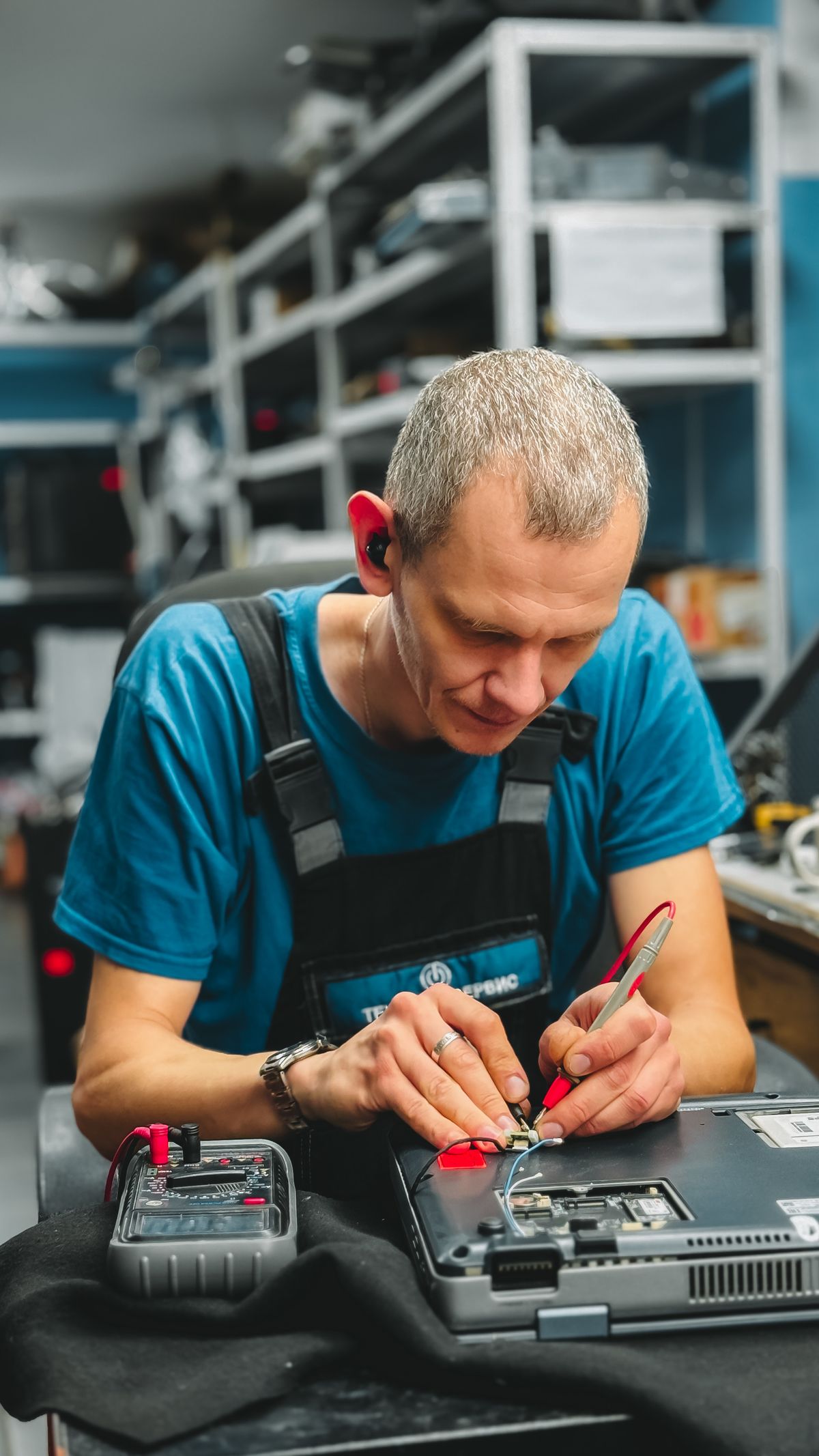 Technician testing and repairing a laptop for dependable service